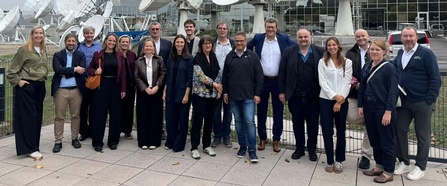 Gruppenbild der Teilnehmer:innen der Trimediale 2026 vor Satelliten-Schüsseln bei SES